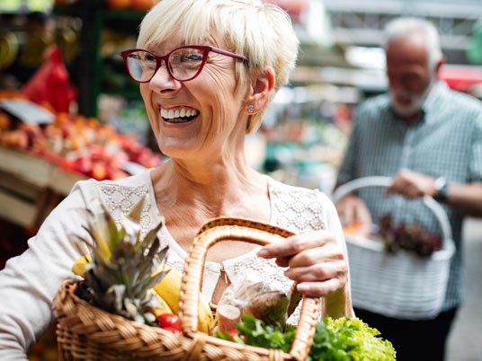 Lady holding basket of produce